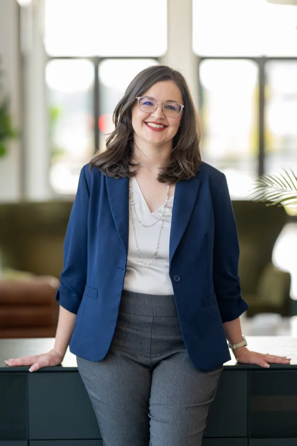 Allison Marx, standing, in a blue jacket.