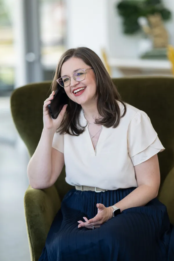 Allison on a call at her desk.